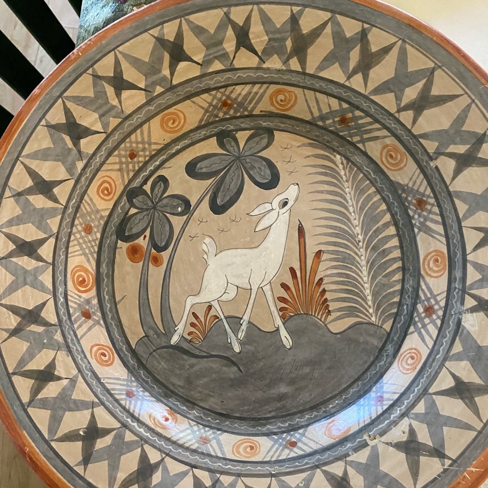 Four Mexican terra cotta plates.